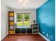 Comfortable window sitting nook with built-in storage and decorative pillows, plus bright blue accent wall at 1774 Timmons Marie Ln, Lincolnton, NC 28092