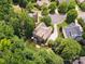 Aerial view of a home surrounded by lush trees and a well-maintained yard at 2103 Lytton Ln, Matthews, NC 28104