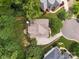 An aerial view displays the home's roof, mature trees, green lawn, circular driveway, and neighborhood setting at 2103 Lytton Ln, Matthews, NC 28104