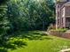 Picturesque backyard with lush greenery and mature trees, offering a serene and private setting at 2103 Lytton Ln, Matthews, NC 28104