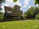 Large, well-maintained backyard with mature trees and lush greenery, offering privacy at 2103 Lytton Ln, Matthews, NC 28104