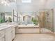 Luxurious bathroom with a soaking tub, a large shower, and double sinks at 2103 Lytton Ln, Matthews, NC 28104