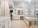 Elegant bathroom featuring a skylight, soaking tub, and a luxurious shower, perfect for relaxation at 2103 Lytton Ln, Matthews, NC 28104