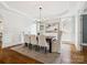 Formal dining room featuring hardwood floors, elegant lighting, and wainscoting at 2103 Lytton Ln, Matthews, NC 28104