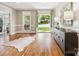 Elegant foyer with hardwood floors, a stylish console table, and double doors leading outside at 2103 Lytton Ln, Matthews, NC 28104