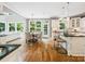 Open-concept kitchen, dining, and living area with hardwood flooring and natural light at 2103 Lytton Ln, Matthews, NC 28104