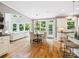 Open-concept area with a kitchen, dining area, and living room featuring hardwood floors and natural light at 2103 Lytton Ln, Matthews, NC 28104