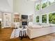 Spacious living room with hardwood floors, a fireplace, built-in shelves, and large windows for natural light at 2103 Lytton Ln, Matthews, NC 28104