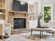 Inviting living room with a stone fireplace and built-in shelving, offering a cozy and stylish space at 2103 Lytton Ln, Matthews, NC 28104