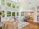A living room features hardwood floors, large windows, and an open layout connecting to the kitchen at 2103 Lytton Ln, Matthews, NC 28104