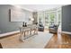 Home office showcasing hardwood floors, an area rug, bay window and ample natural light at 2103 Lytton Ln, Matthews, NC 28104