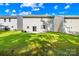 Large backyard with green grass, a patio, and houses nearby, perfect for Gathering activities at 2316 Savannah Hills Dr, Matthews, NC 28105
