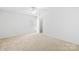Clean, carpeted bedroom with white walls, and white ceiling fan at 2316 Savannah Hills Dr, Matthews, NC 28105