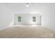 Spacious bedroom features neutral walls, carpet, and double windows, offering ample natural light at 2316 Savannah Hills Dr, Matthews, NC 28105