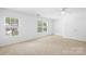 Bright, carpeted bedroom with two windows and white ceiling fan is ready for move in at 2316 Savannah Hills Dr, Matthews, NC 28105