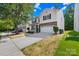 Charming two-story home featuring vinyl siding, brick accents, and an attached two-car garage at 2316 Savannah Hills Dr, Matthews, NC 28105