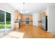 Modern kitchen featuring stainless steel appliances, wood cabinets, and hardwood flooring at 2316 Savannah Hills Dr, Matthews, NC 28105