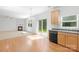 Bright kitchen featuring wood cabinets, black appliances, and sliding glass doors to the backyard at 2316 Savannah Hills Dr, Matthews, NC 28105