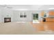 Open living space featuring a fireplace, ceiling fan, and sliding door access to the backyard at 2316 Savannah Hills Dr, Matthews, NC 28105