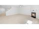 Cozy living room with a fireplace, stairway and plush carpeting at 2316 Savannah Hills Dr, Matthews, NC 28105