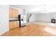 Open-concept living room with hardwood floors, stainless steel appliances, and fireplace, great for entertaining at 2316 Savannah Hills Dr, Matthews, NC 28105