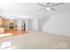 Open living area showcasing a kitchen, staircase, and hardwood-carpet flooring combination at 2316 Savannah Hills Dr, Matthews, NC 28105