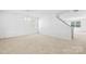 Bright living room with neutral carpet, white walls, and staircase, providing natural light at 2316 Savannah Hills Dr, Matthews, NC 28105