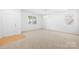 Bright living room with neutral carpet, white walls, and a window offering natural light at 2316 Savannah Hills Dr, Matthews, NC 28105