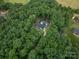Breathtaking aerial view of a secluded home nestled within a dense canopy of lush trees and a sparkling pool at 2418 Shuford Rd, Lincolnton, NC 28092
