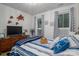 Cozy bedroom featuring charming decor, two windows, and a TV on a wooden dresser at 2418 Shuford Rd, Lincolnton, NC 28092