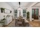 Dining room with wooden table, bench seating, bright windows, and stylish light fixture at 2418 Shuford Rd, Lincolnton, NC 28092