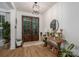 Inviting entryway with wood floors, decorative table, large double doors, and modern light fixture at 2418 Shuford Rd, Lincolnton, NC 28092