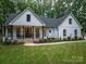 Beautiful two-story home featuring a charming front porch, manicured landscaping, and a freshly cut lawn, perfect curb appeal at 2418 Shuford Rd, Lincolnton, NC 28092