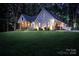 Stunning two-story home featuring a lush green lawn, inviting front porch, and attached garage with a well-lit exterior at 2418 Shuford Rd, Lincolnton, NC 28092