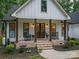 Charming farmhouse front porch with brick steps, rocking chairs and double doors at 2418 Shuford Rd, Lincolnton, NC 28092