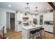 Modern kitchen with white cabinets, quartz countertops, stainless steel appliances, island with seating, and wood accents at 2418 Shuford Rd, Lincolnton, NC 28092
