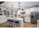 Bright, modern kitchen with white cabinetry, quartz countertops, stainless steel appliances, and island with seating at 2418 Shuford Rd, Lincolnton, NC 28092