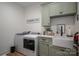 Well-equipped laundry room with modern washer and dryer, ample counter space, and stylish cabinets at 2418 Shuford Rd, Lincolnton, NC 28092