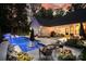 Backyard pool featuring illuminated fountains, in-pool seating, and a patio area perfect for relaxing and entertaining guests at 2418 Shuford Rd, Lincolnton, NC 28092