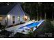 Backyard pool featuring illuminated fountains, in-pool seating, and a patio area perfect for relaxing and entertaining guests at 2418 Shuford Rd, Lincolnton, NC 28092