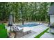 Inviting backyard pool area with lounge seating and lush landscaping for outdoor relaxation at 2418 Shuford Rd, Lincolnton, NC 28092
