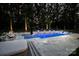 Backyard pool featuring illuminated fountains, in-pool seating, and a patio area perfect for relaxing and entertaining guests at 2418 Shuford Rd, Lincolnton, NC 28092