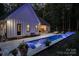Backyard pool featuring illuminated fountains, in-pool seating, and a patio area perfect for relaxing and entertaining guests at 2418 Shuford Rd, Lincolnton, NC 28092