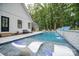 Gorgeous outdoor pool with modern white lounge chairs and a pristine outdoor lounge area at 2418 Shuford Rd, Lincolnton, NC 28092