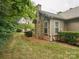 Exterior view of stone and siding with chimney, surrounded by mature trees and landscaped yard at 2656 Polo Club Blvd, Matthews, NC 28105