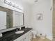 Modern bathroom with granite counters, updated fixtures, and tiled shower at 2656 Polo Club Blvd, Matthews, NC 28105