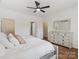 Bright bedroom featuring new floors, a ceiling fan, a walk-in closet, and a stylish dresser at 2656 Polo Club Blvd, Matthews, NC 28105