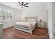 Relaxing bedroom with a ceiling fan, wood floors, and lots of light from the windows at 2656 Polo Club Blvd, Matthews, NC 28105
