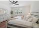 Bright and stylish bedroom features new floors, a ceiling fan, and lots of natural light at 2656 Polo Club Blvd, Matthews, NC 28105