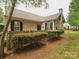 Attractive stone and siding home with manicured landscaping and a cozy, fenced entrance at 2656 Polo Club Blvd, Matthews, NC 28105